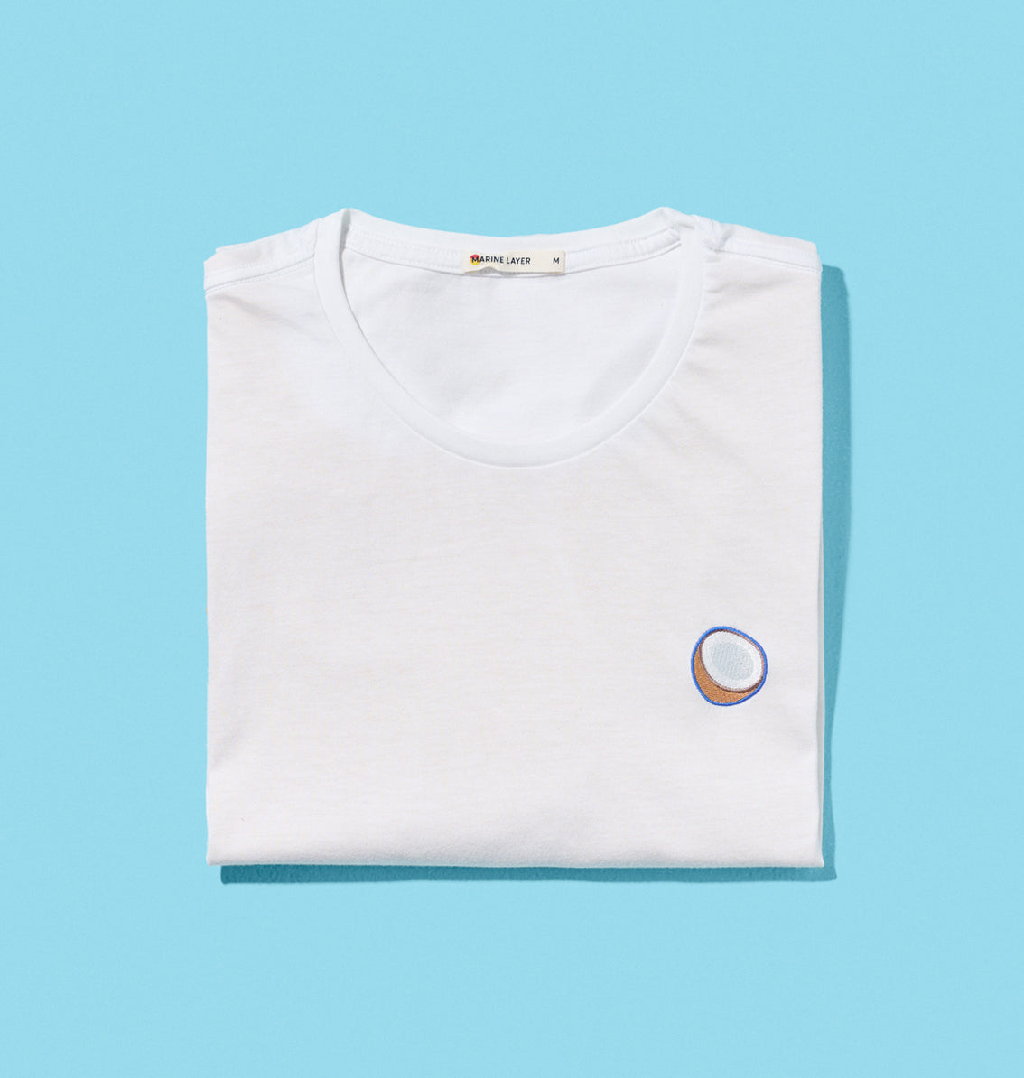 An embroidered Coconut Crewneck Tee with a Vita Coco coconut goodness circle design, perfect as a wardrobe staple.