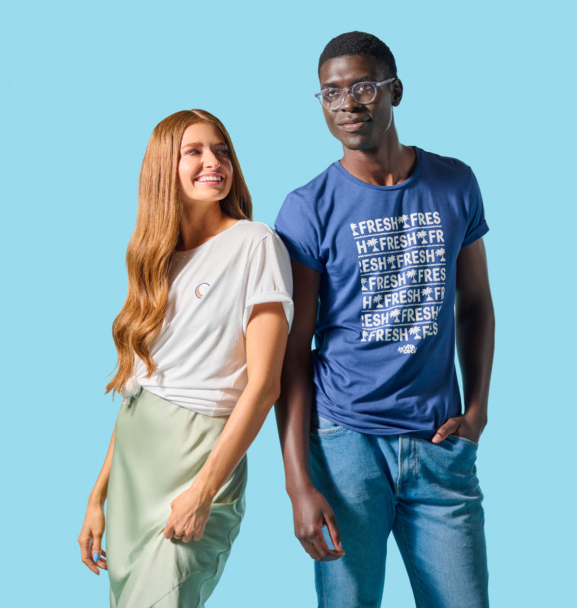 A man and woman standing next to each other wearing Vita Coco's Coconut Crewneck Tees, a wardrobe staple that exudes coconut goodness.