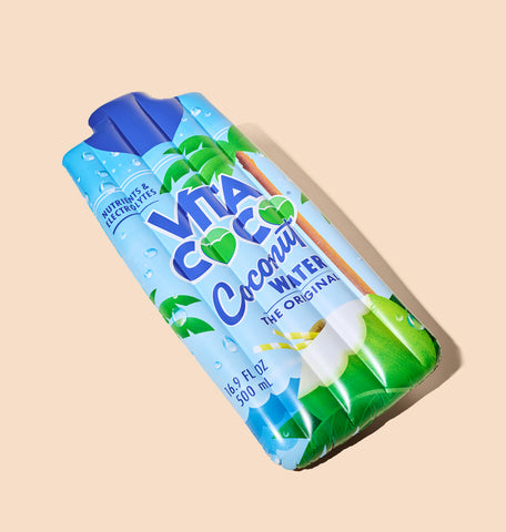 A Reversible Coconut Water Floatie by Vita Coco against a beige background.