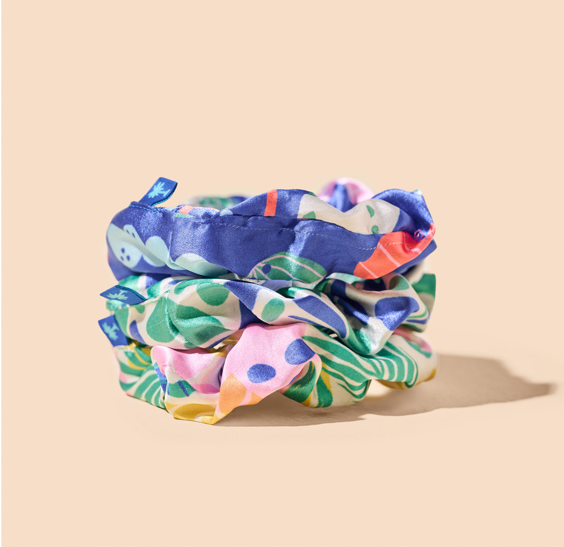 A vibrant Vita Coco scrunchie with a tropical pattern, perfect to add a pop of color to your hair.